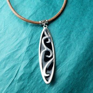 2/10$ Silver tone pendant on brown faux leather